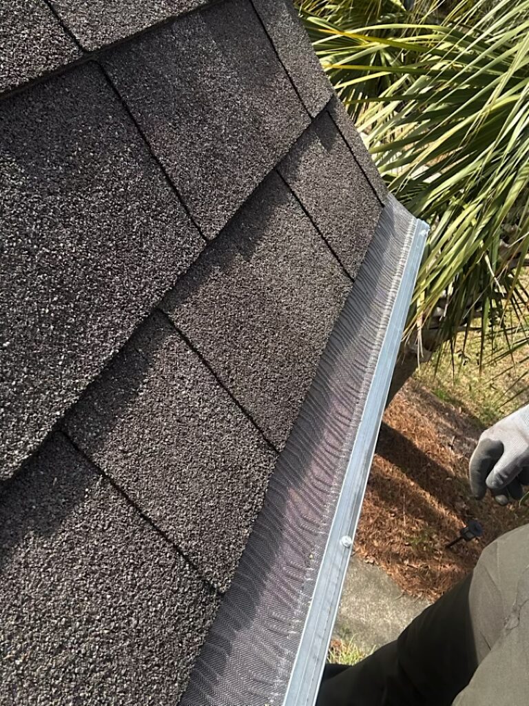 Installed gutter guards with a shingle roof.