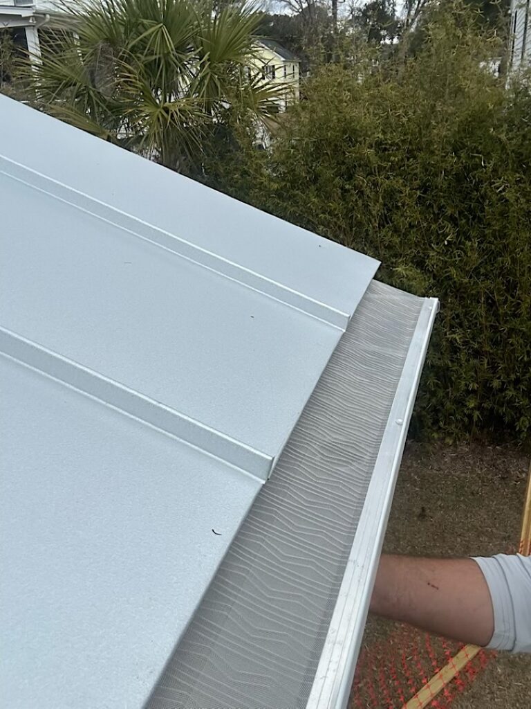 Installation of our stainless steel micro mesh gutter guards with a metal roof.