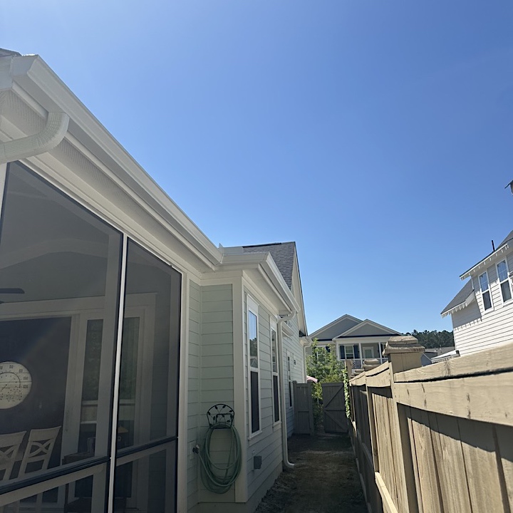Summerville gutter installation in Nexton on light blue house, side view