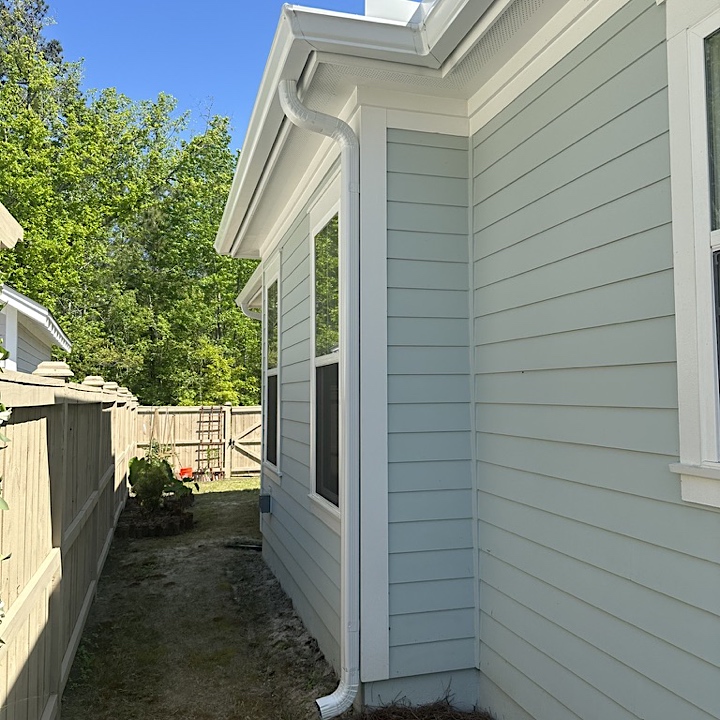 Summerville gutter installation in Nexton on light blue house, other side of home