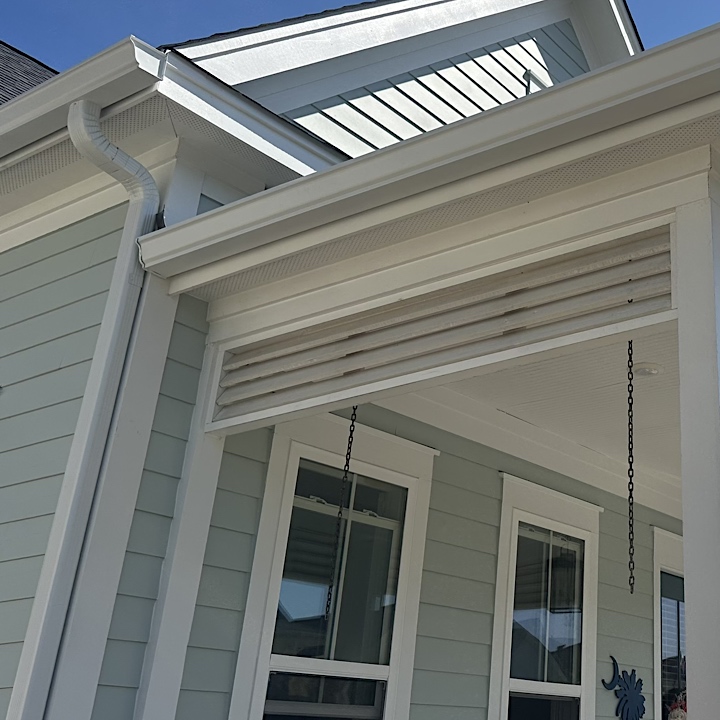 Summerville gutter installation in Nexton on light blue house, side of front porch