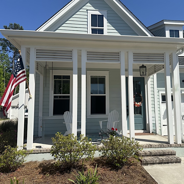 Summerville gutter installation in Nexton on light blue house, gutter across front of home
