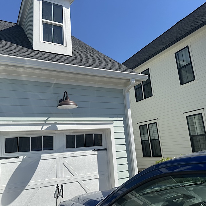 Summerville gutter installation in Nexton on light blue house, gutter across garage.