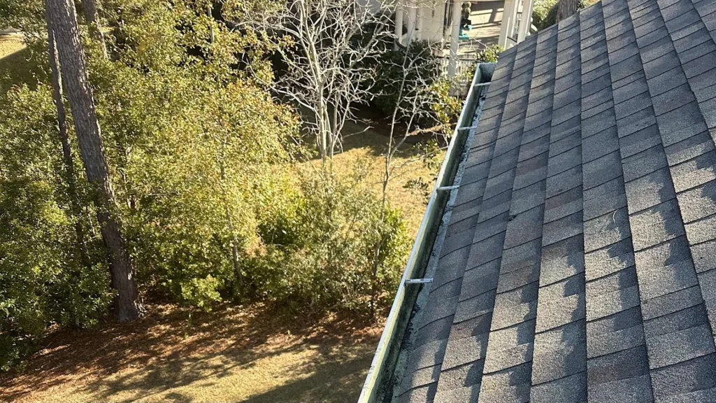 Arial view from roof of gutters being cleaned.