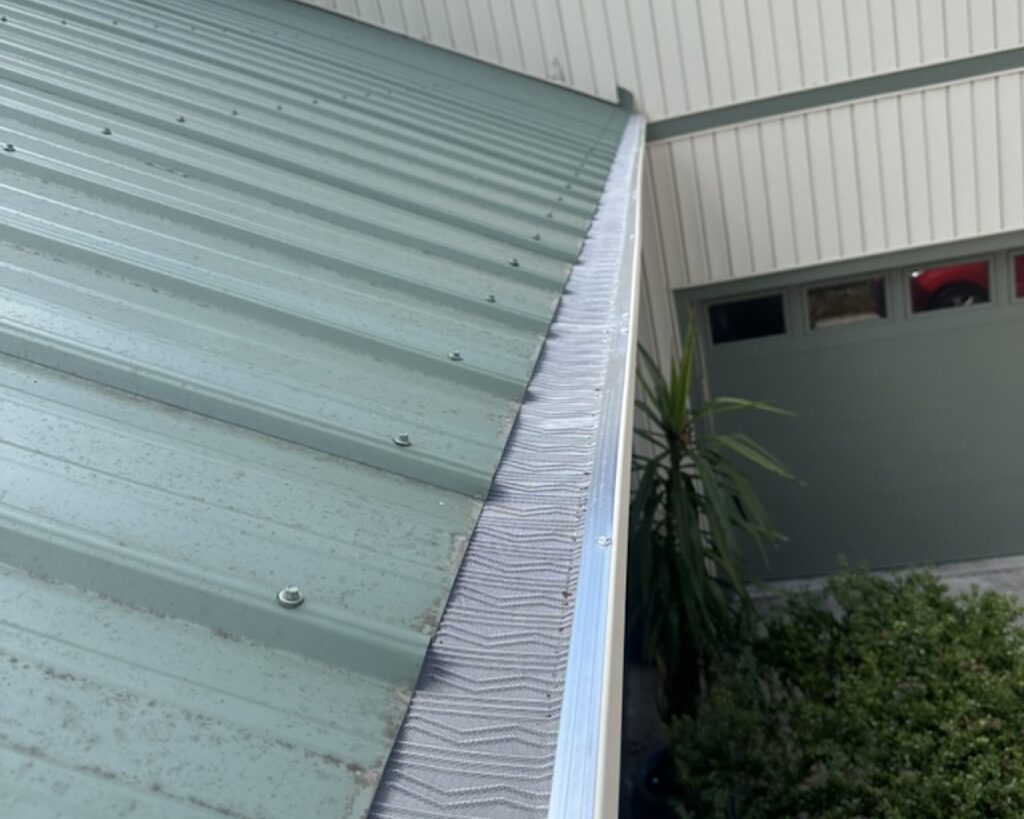 Micro mesh gutter guards installed on house with green roof and wicker gutters in Summerville, SC near Gahagen
