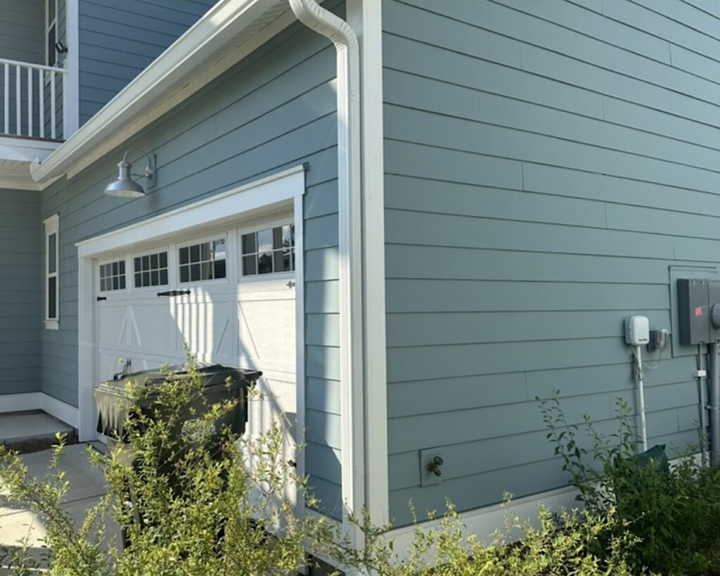 Gutter installation over a garage with a 10' 3"x4" downspout and elbows in Cane Bay community